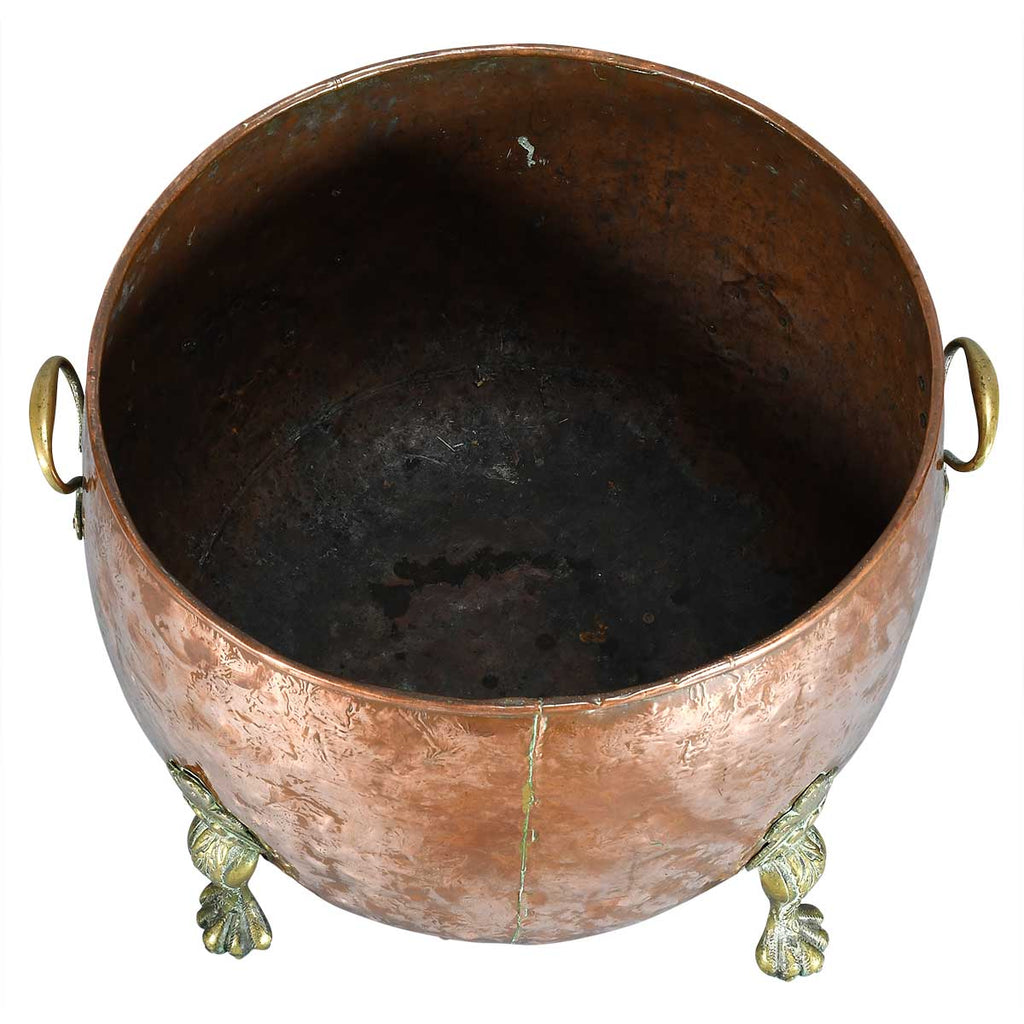 A Large Circular Copper Bin on Brass Paw Feet