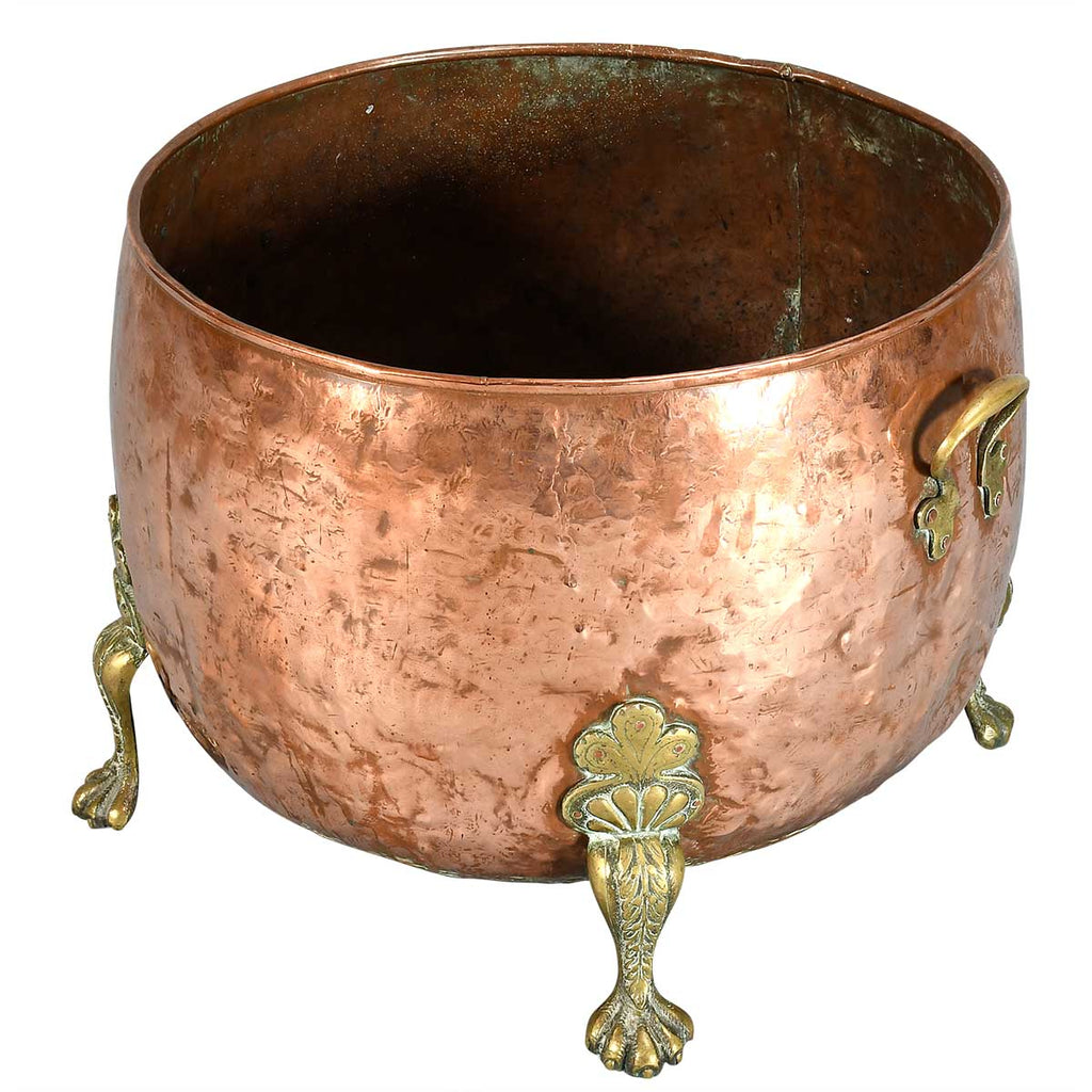 A Large Circular Copper Bin on Brass Paw Feet