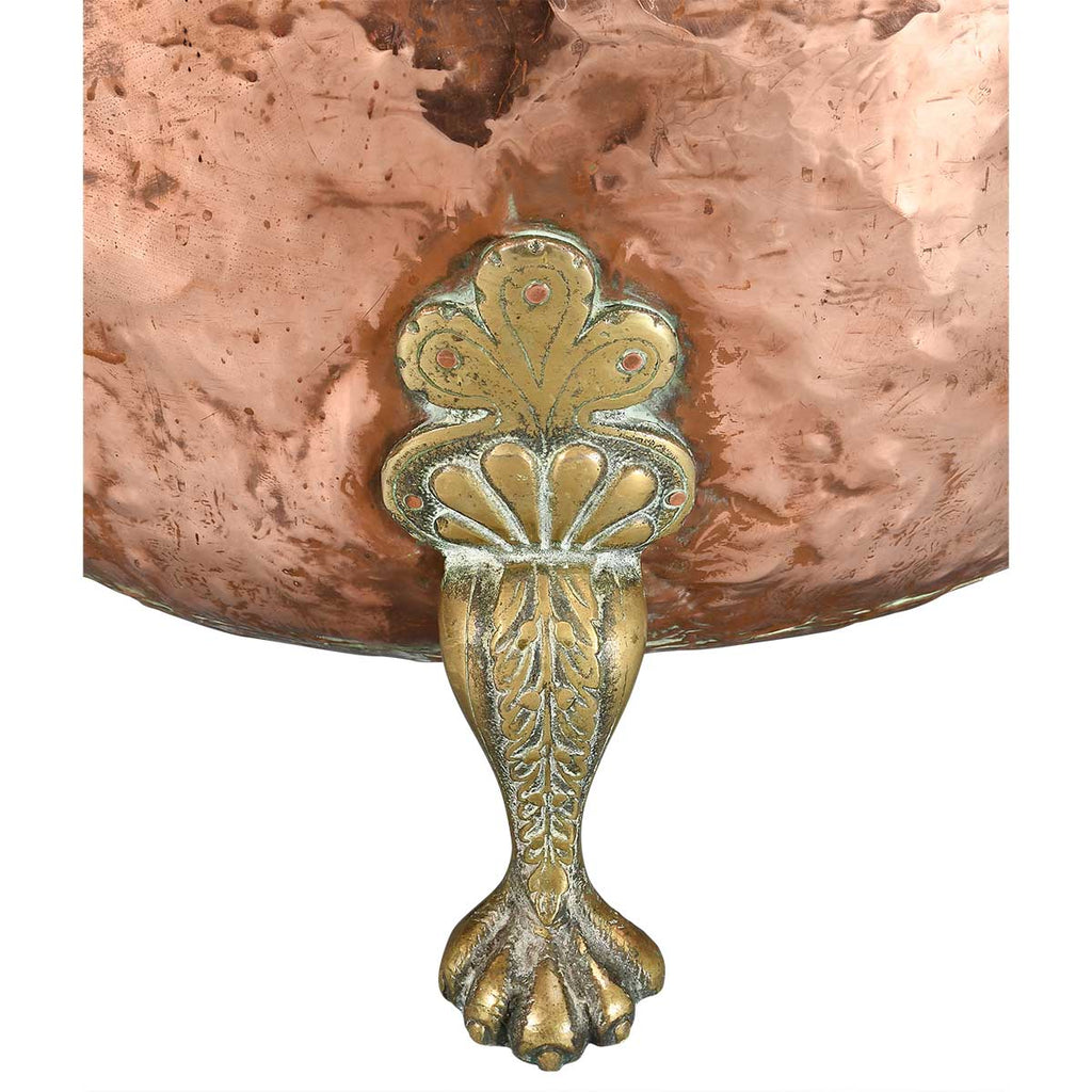 A Large Circular Copper Bin on Brass Paw Feet