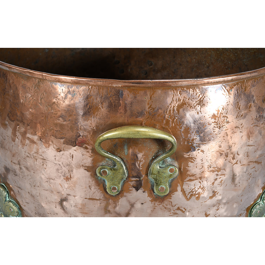 A Large Circular Copper Bin on Brass Paw Feet