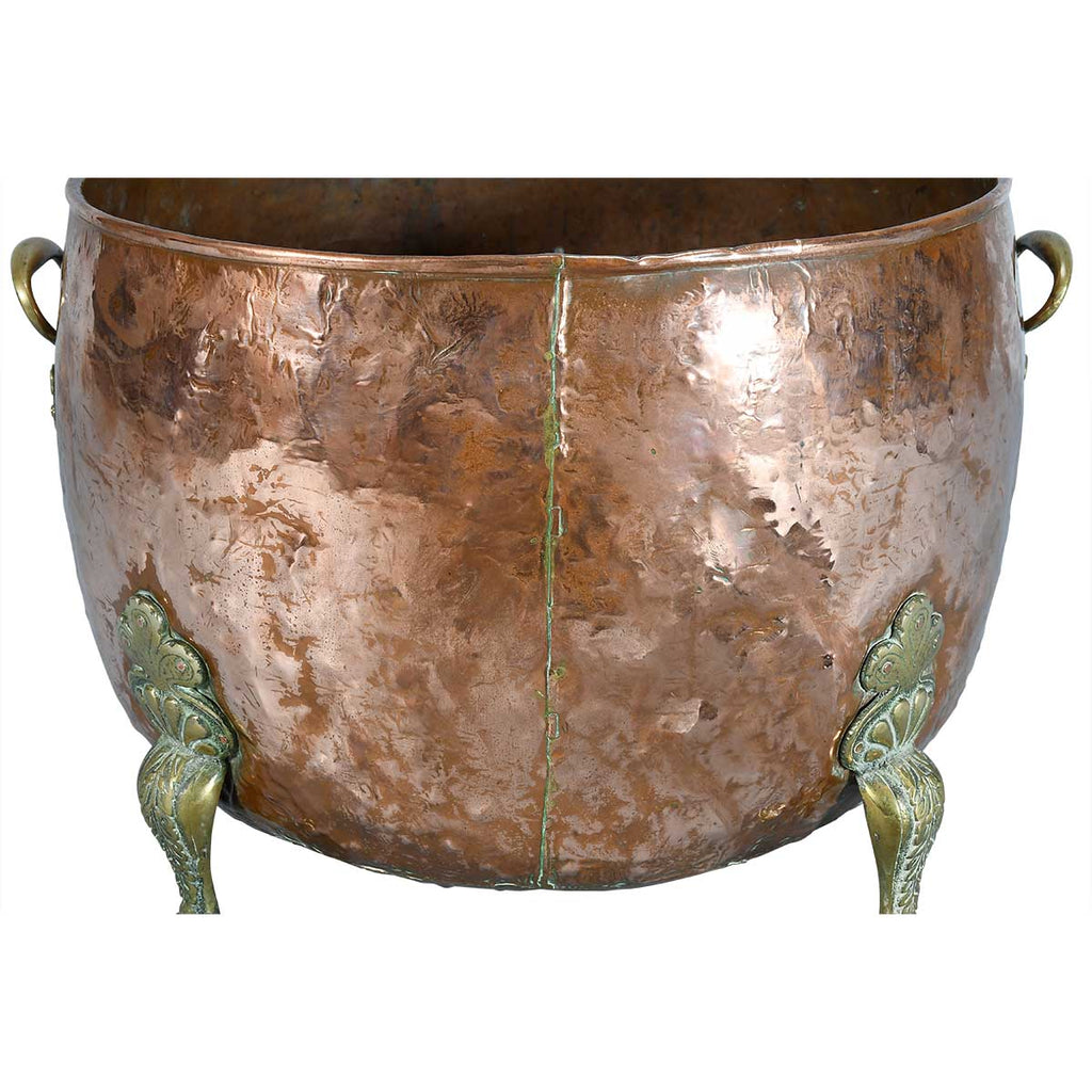A Large Circular Copper Bin on Brass Paw Feet