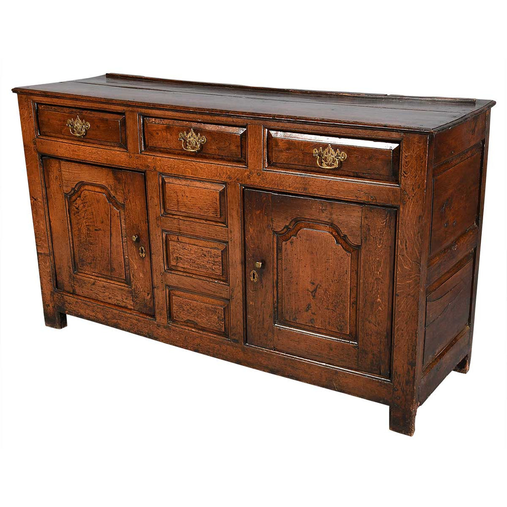 A Queen Anne Period Oak Dresser with Three Drawers over Two Cupboards