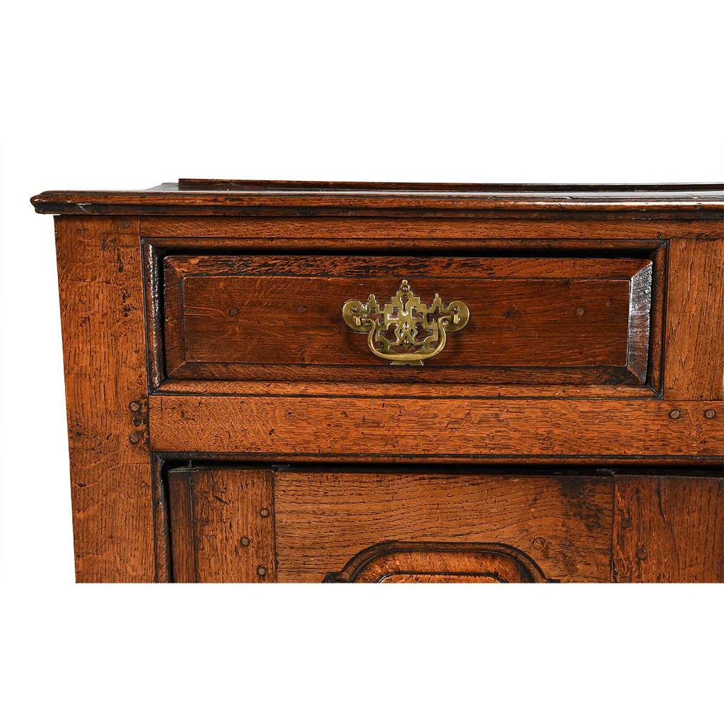 A Queen Anne Period Oak Dresser with Three Drawers over Two Cupboards