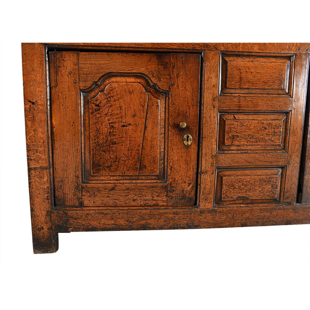 A Queen Anne Period Oak Dresser with Three Drawers over Two Cupboards