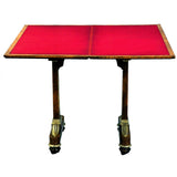 Amboyna card table with gilt accents and recessed castors. View 2