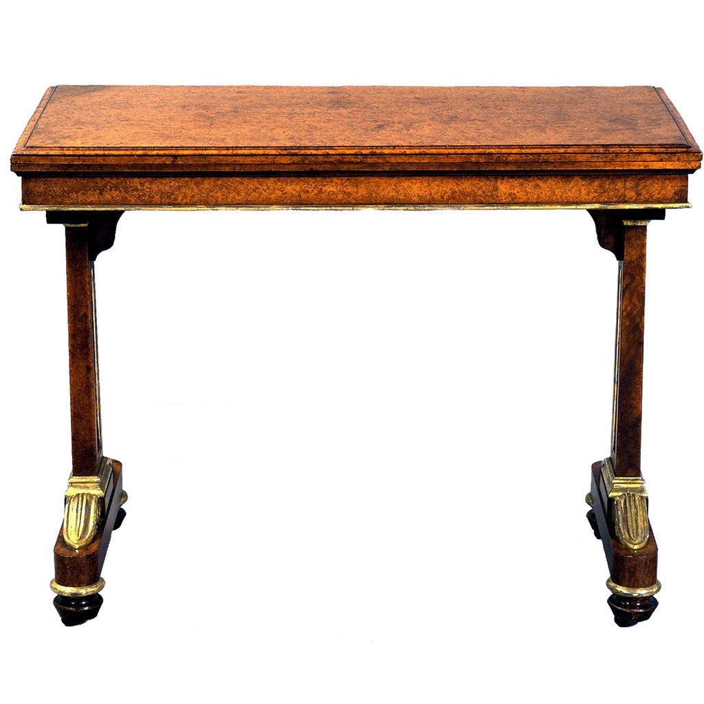 Amboyna card table with gilt accents and recessed castors. View 3