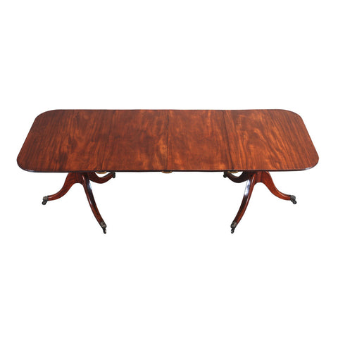 An English mahogany dining table with rounded rectangular top. view 1