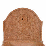 A 17th century marble font with arched backsplat on a pedestal base. View 3
