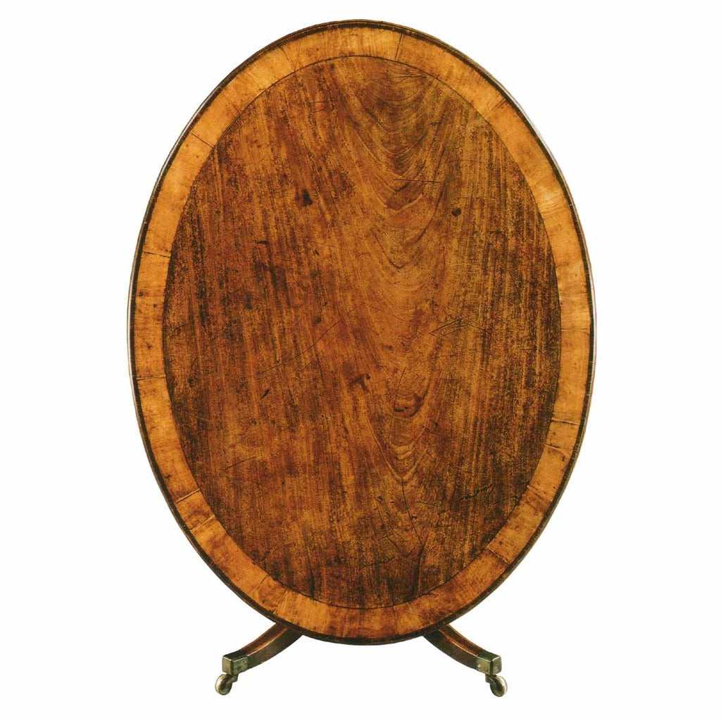 An English oval breakfast table with wide strip of cross-banding and incredible color and patina. view 1