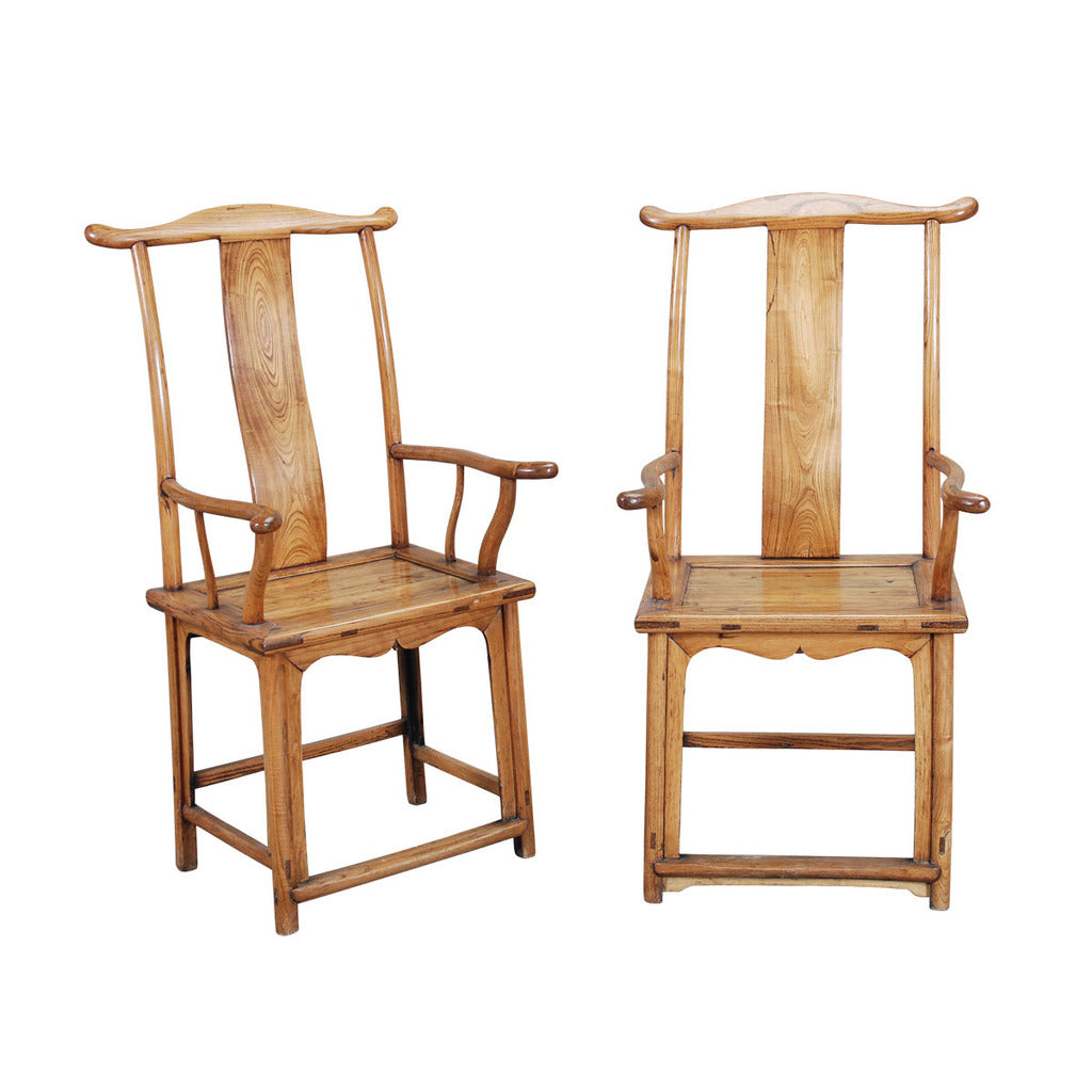 
A pair of Chinese yoke-back armchairs of traditional form with well-shaped arms and crest-rail, undulating backsplat, and connecting stretchers. view 1