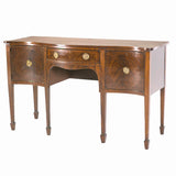 An English Sheraton period sideboard with serpentine shaped front. view 1