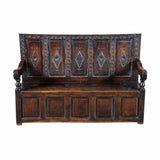 An antique Charles II period oak settle with a raised-paneled back. view 2