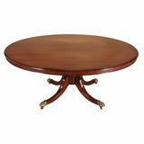 An English mahogany dining table on turned pedestal with four-splay legs. view 1