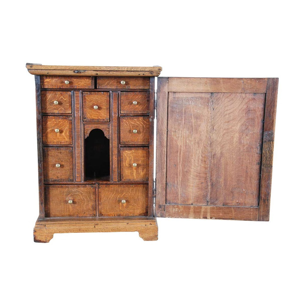 An 18th century English oak spice cupboard on bracket feet. view 2