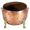 A Large Circular Copper Bin on Brass Paw Feet