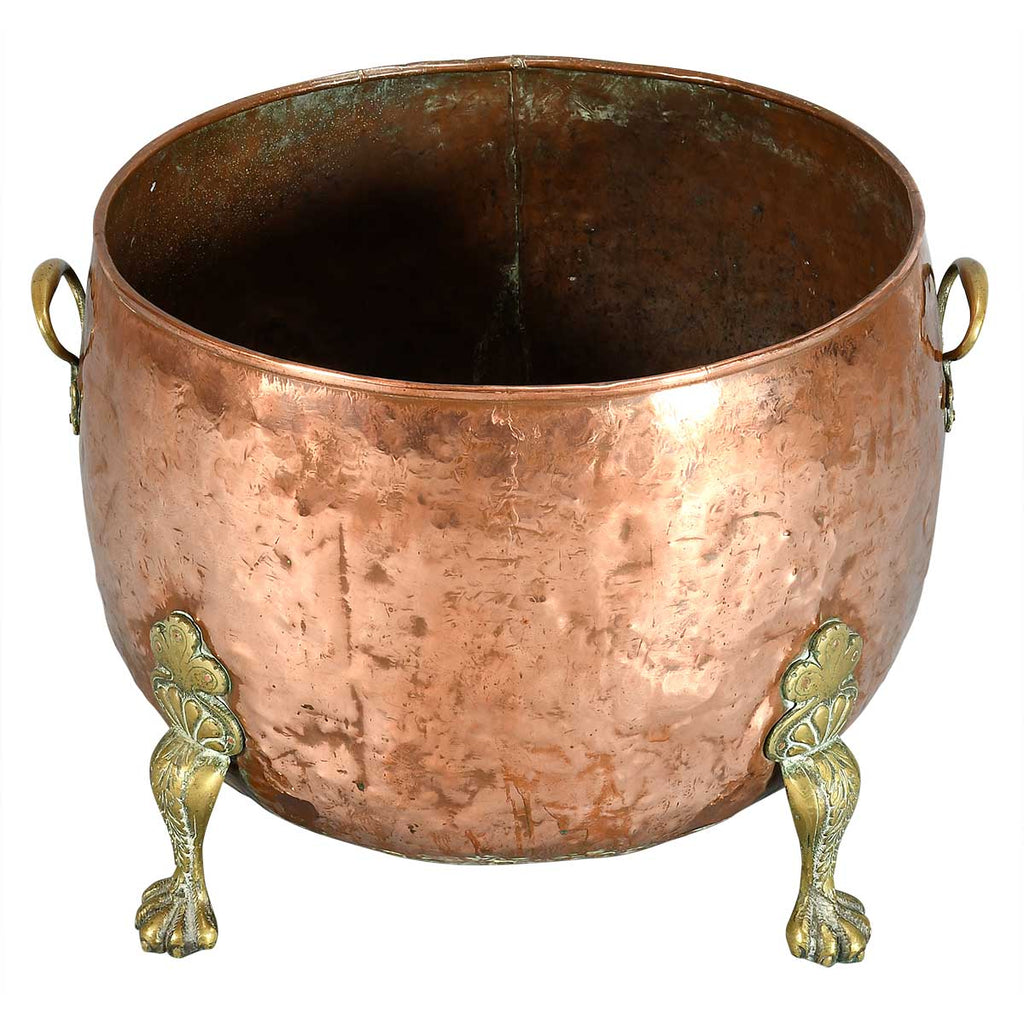 A Large Circular Copper Bin on Brass Paw Feet