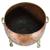 A Large Circular Copper Bin on Brass Paw Feet
