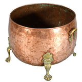 A Large Circular Copper Bin on Brass Paw Feet