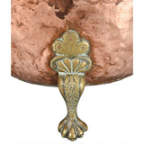 A Large Circular Copper Bin on Brass Paw Feet