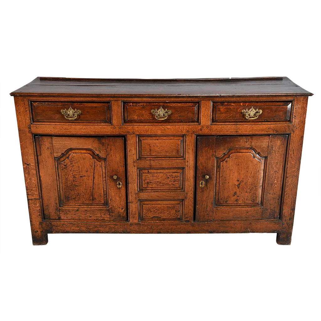 A Queen Anne Period Oak Dresser with Three Drawers over Two Cupboards