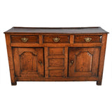 A Queen Anne Period Oak Dresser with Three Drawers over Two Cupboards