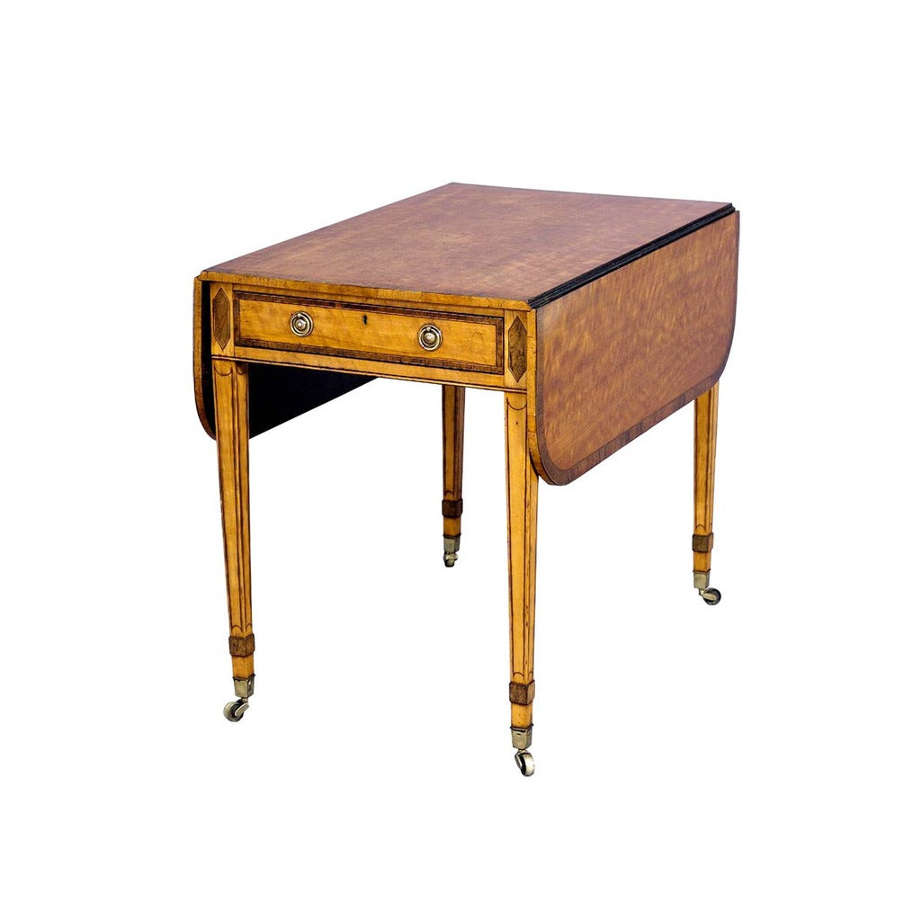 A 18th century Sheraton period satinwood pembroke table with cross-banded top and drawer. view 1