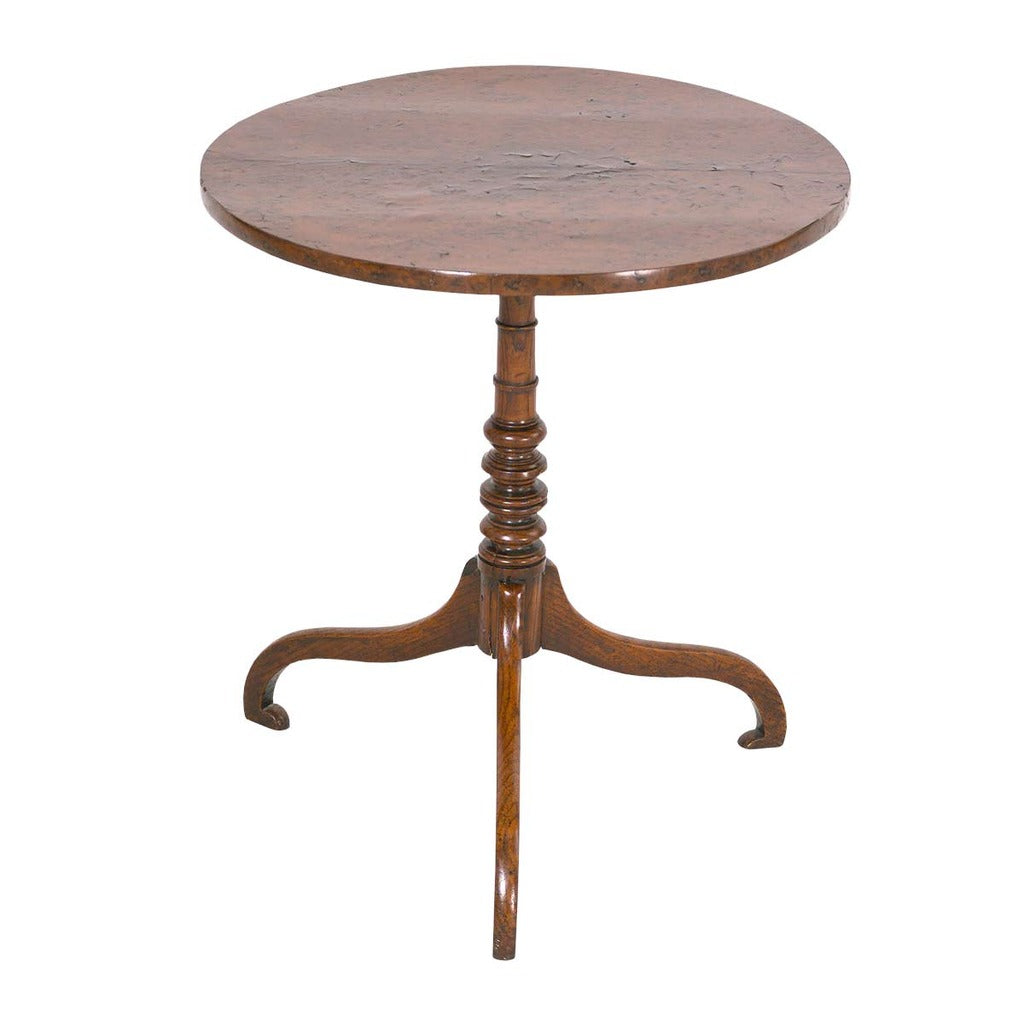 A 19th century burl tripod table on turned pedestal. view 1