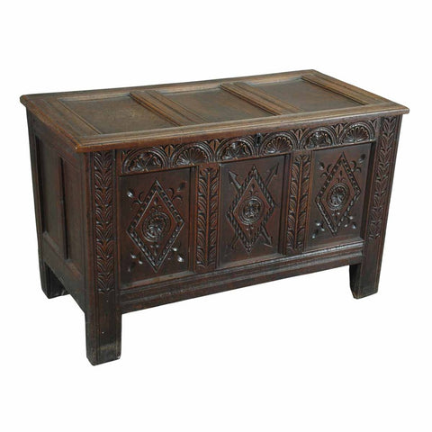 An English oak coffer with three diamond-carved panels across the front and paneled lid. view 1