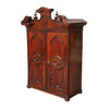 An Italian walnut cabinet with elaborately shaped cornice surmounted by turned finials. view 1