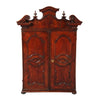 An Italian walnut cabinet with elaborately shaped cornice surmounted by turned finials. view 2