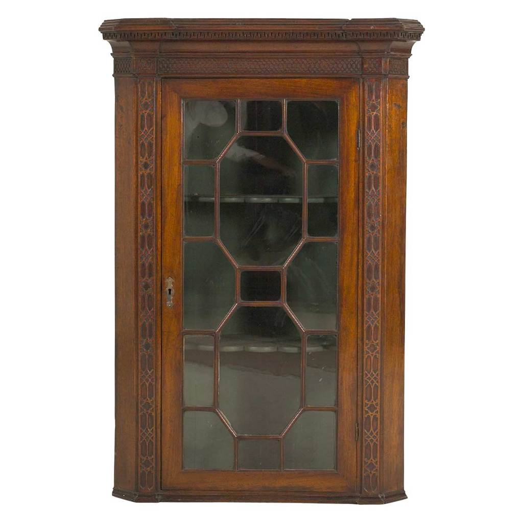 An English mahogany hanging corner cabinet with glazed doors. view 1