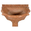 A 17th century marble font with arched backsplat on a pedestal base. View 2