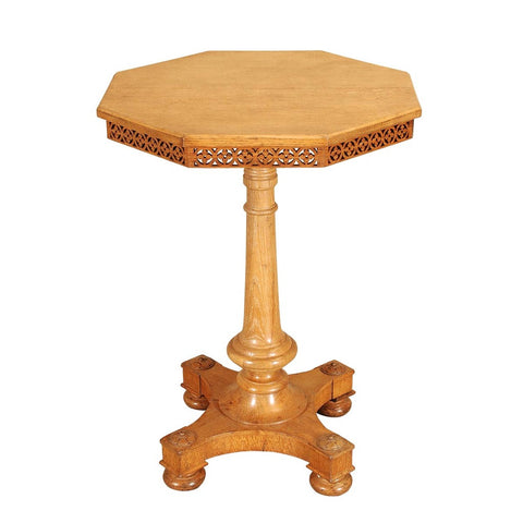 A 19th century oak octagonal lamp table with open fretwork frieze. view 1