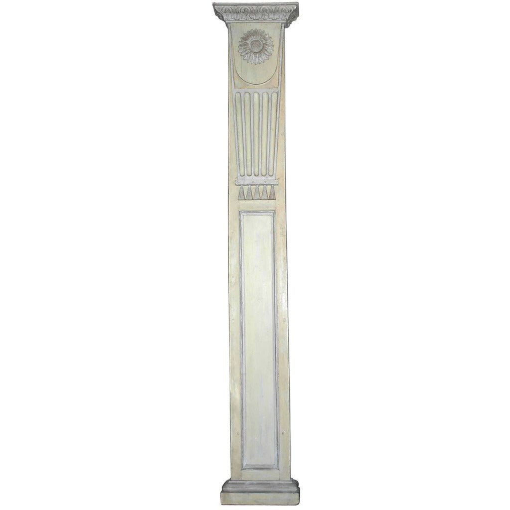A pair of tall, 18th century painted pilasters with carved sunflower motif. view 1