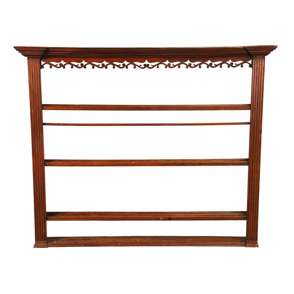 An English oak hanging rack with fluted columns and open fretwork just below the cornice. view 1