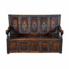 An antique Charles II period oak settle with a raised-paneled back. view 2