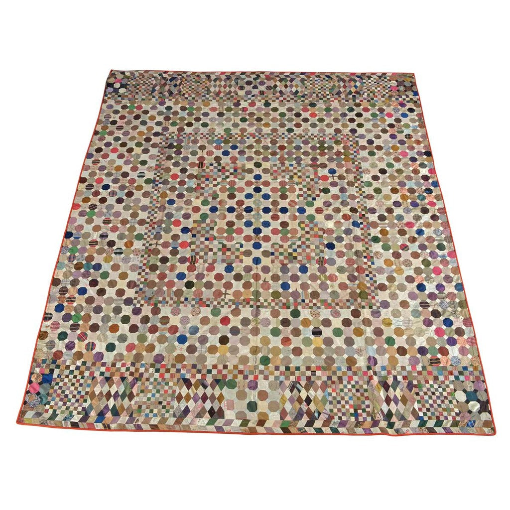 A 19th Century antique English quilt composed of octagonal, square, and diamond-shaped silk patches. View 1
