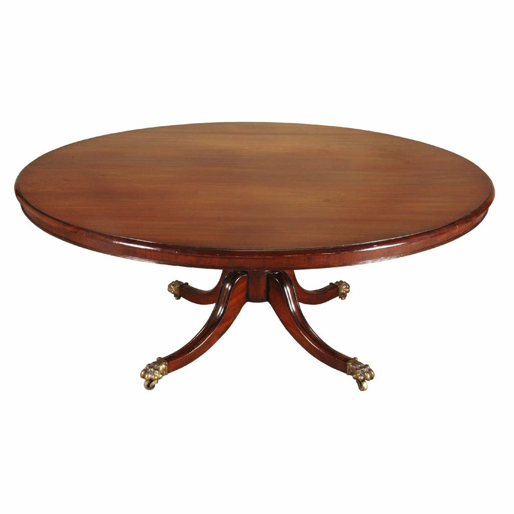 An English mahogany dining table on turned pedestal with four-splay legs. view 1
