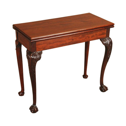 A mahogany tea table with carved cabriole legs ending in ball and claw feet. view 1