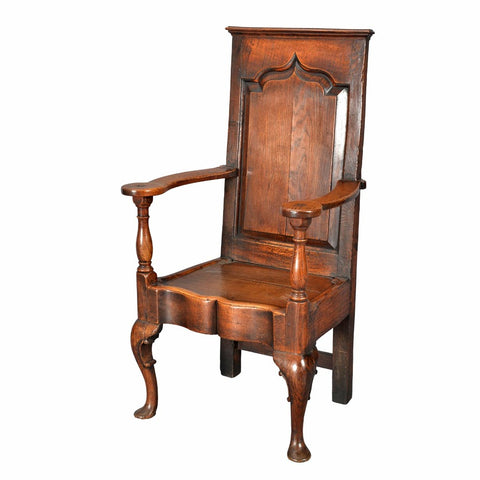 An antique oak wainscot chair with shaped and fielded panel back. view 1