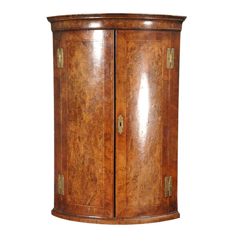 A bow-fronted burl walnut hanging corner cupboard with feather-banding and excellent color. view 1