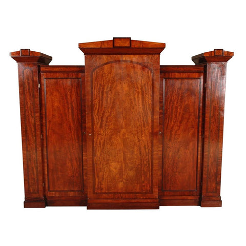 An antique breakfronted mahogany wardrobe with cross-banded doors. view 1