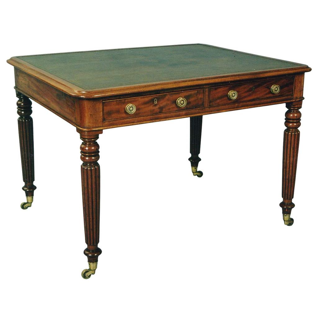 A two-sided 19th century writing table on tapered, reeded legs ending in brass cup casters. view 1